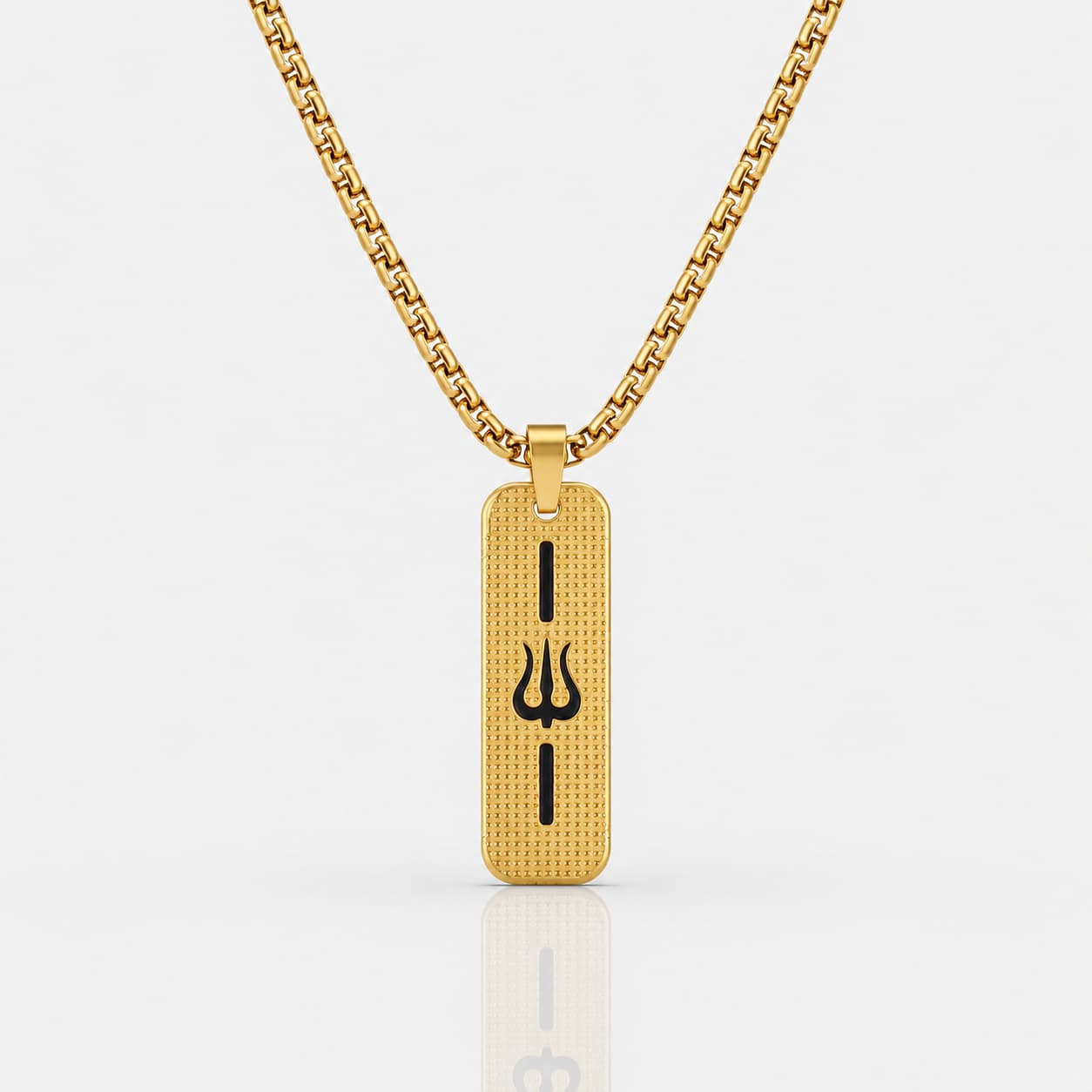 A gold-toned rectangular pendant necklace with a black Trishul symbol in the center, suspended from a matching gold chain against a light gray background.