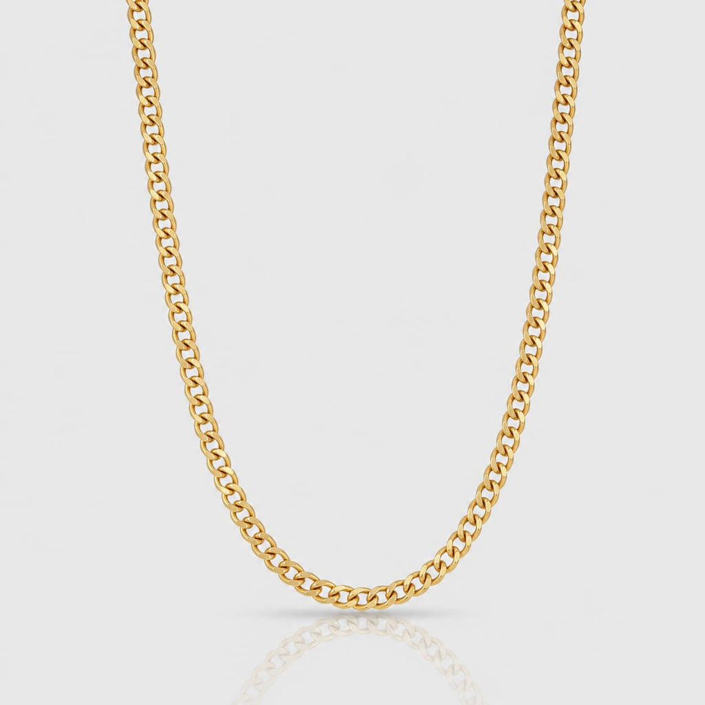 Gold chain necklace on a light gray background