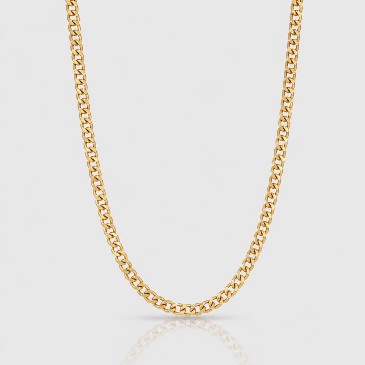 Gold chain necklace on a light gray background