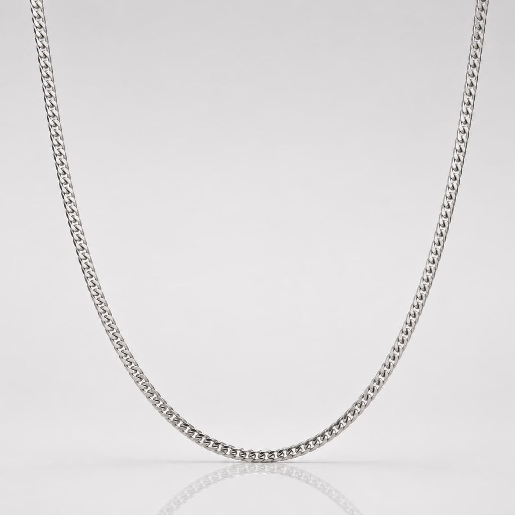 Silver chain necklace on a light gray background