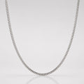 Silver chain necklace on a light gray background