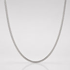 Silver chain necklace on a light gray background