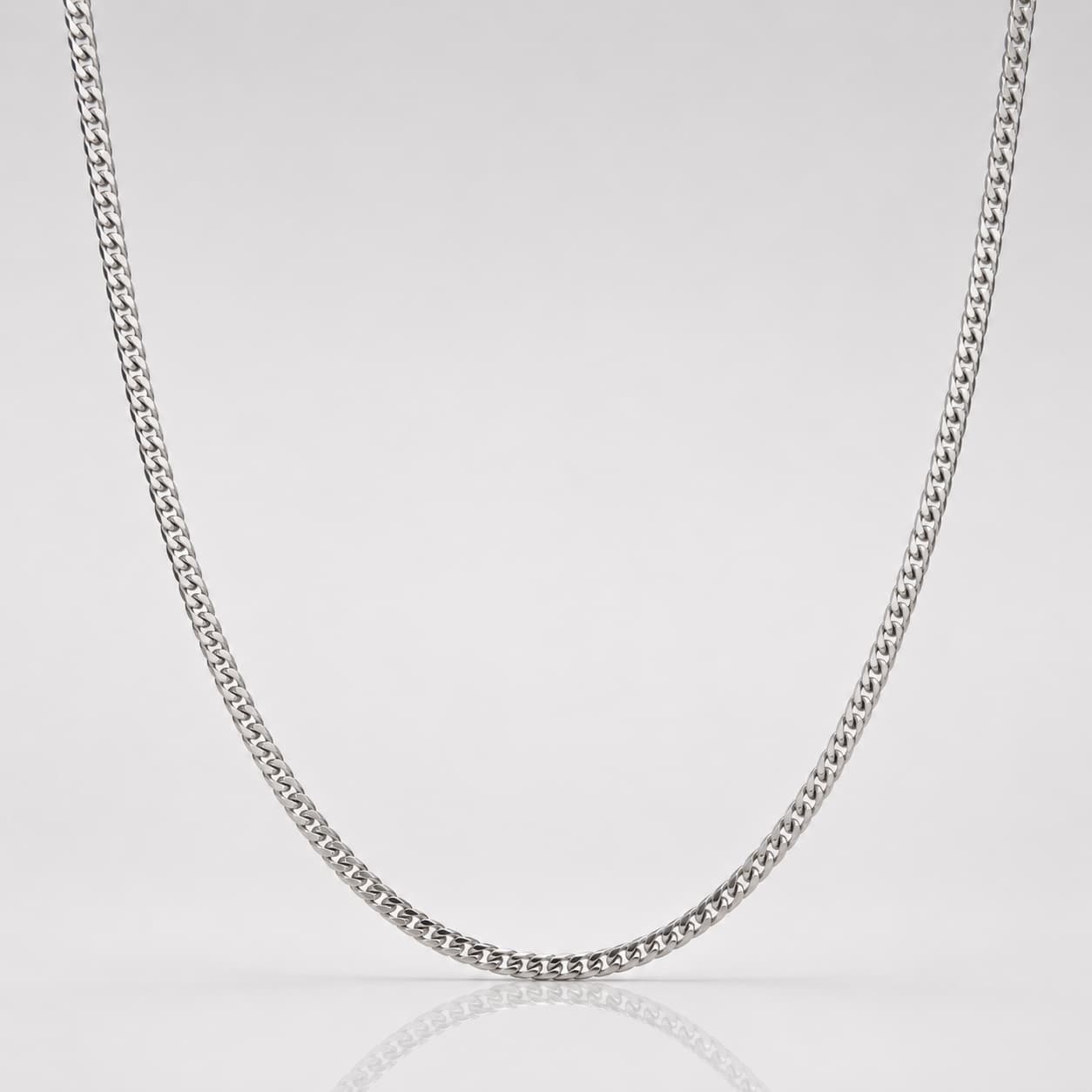 Silver chain necklace on a light gray background