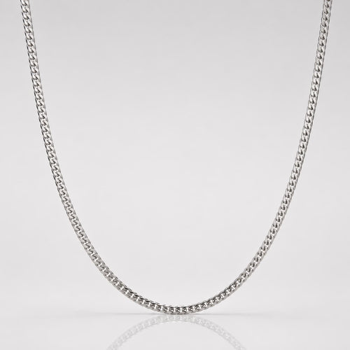 Silver chain necklace on a light gray background