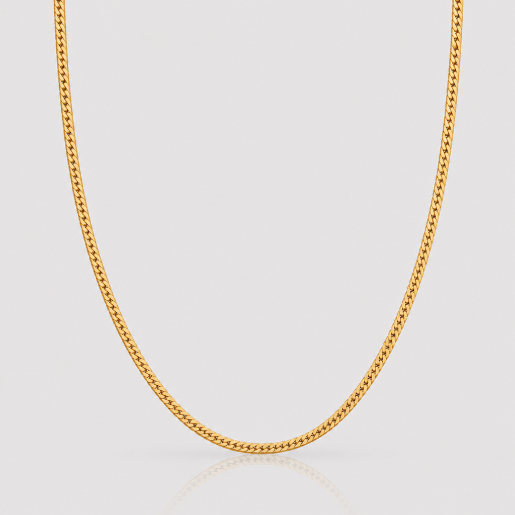 Gold chain necklace on a light gray background