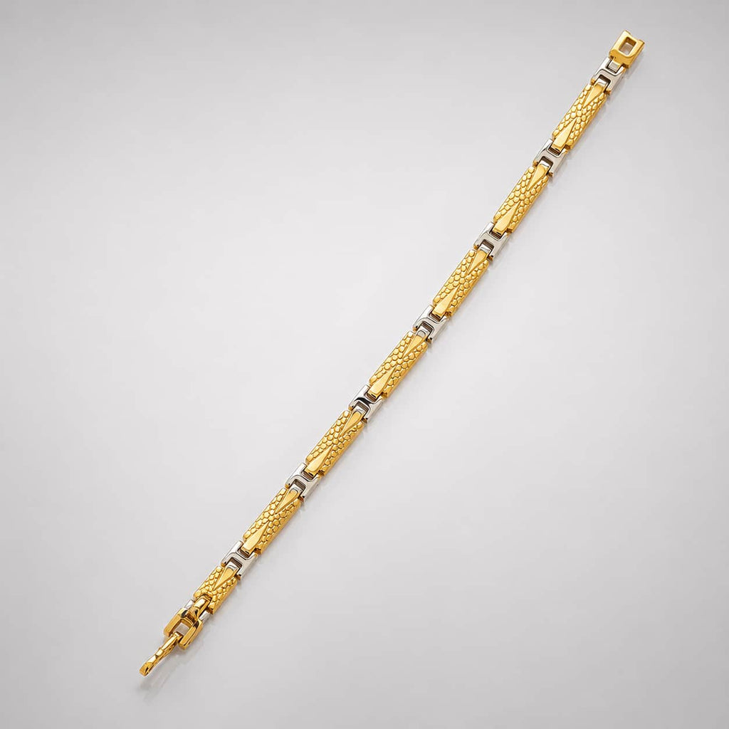A gold-toned two-tone link bracelet with textured and polished segments, displayed diagonally on a light gray background.
